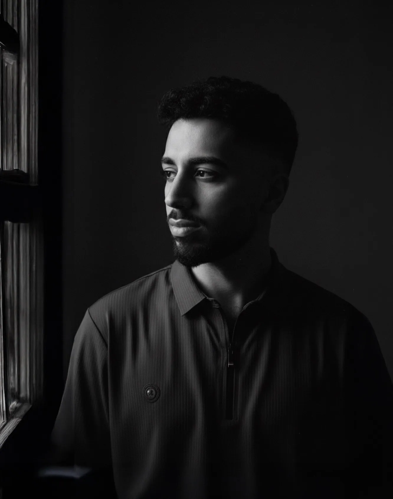 Hajo Sabri — black-and-white portrait beside a window